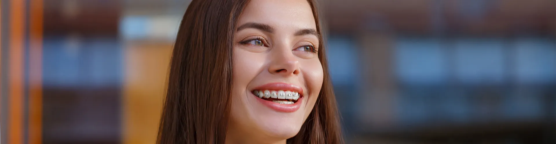 Woman with dental braces smiling.