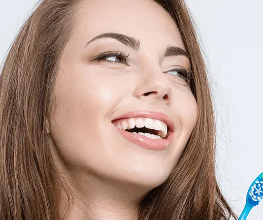 Beautiful smiling woman showing dental veneers cosmetic dentistry