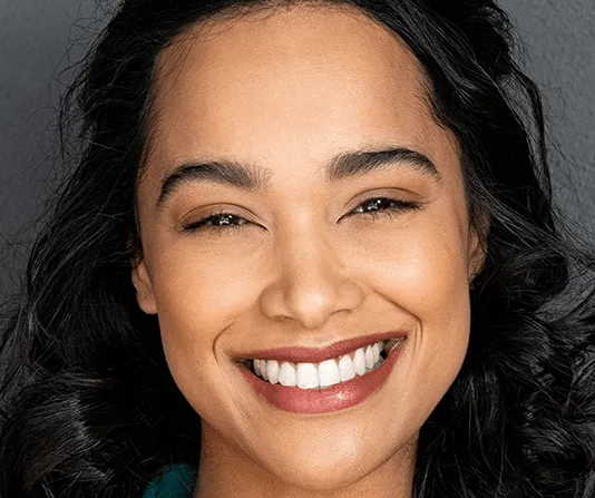 Cosmetic dentistry patient smiling and singing with a toothbrush