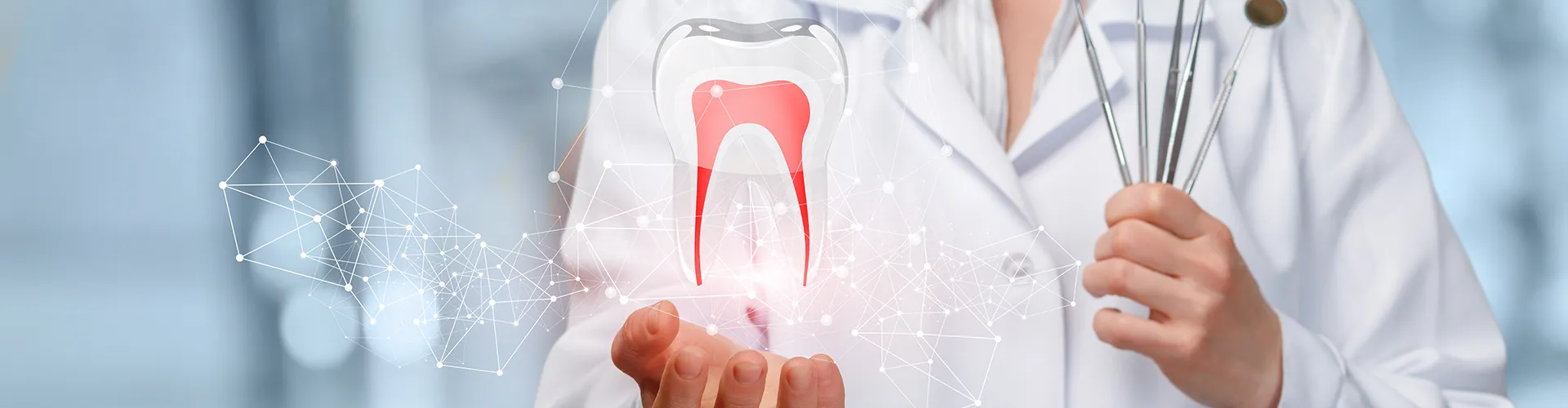 Dentist holding dental tools in one hand and a hologram tooth in the other.
