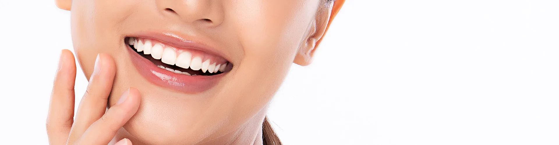 Smiling woman with hand beside her face.