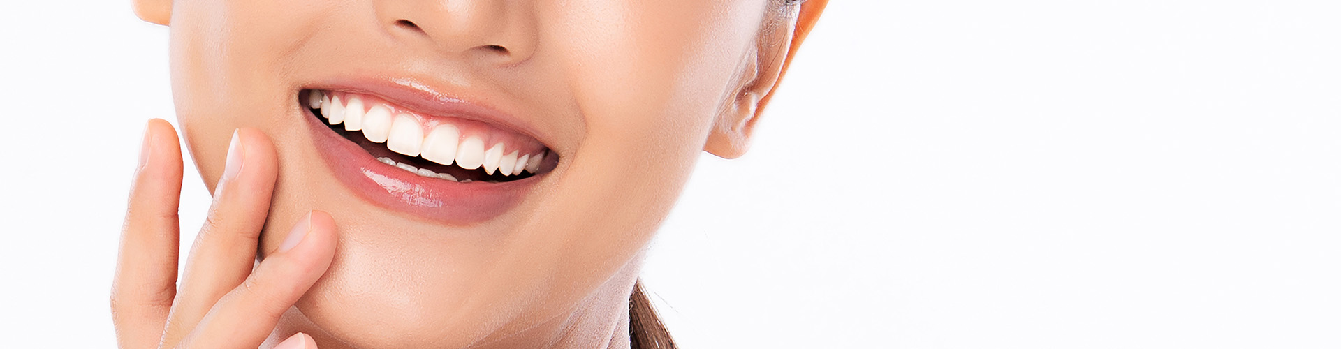 Smiling woman with hand beside her face.