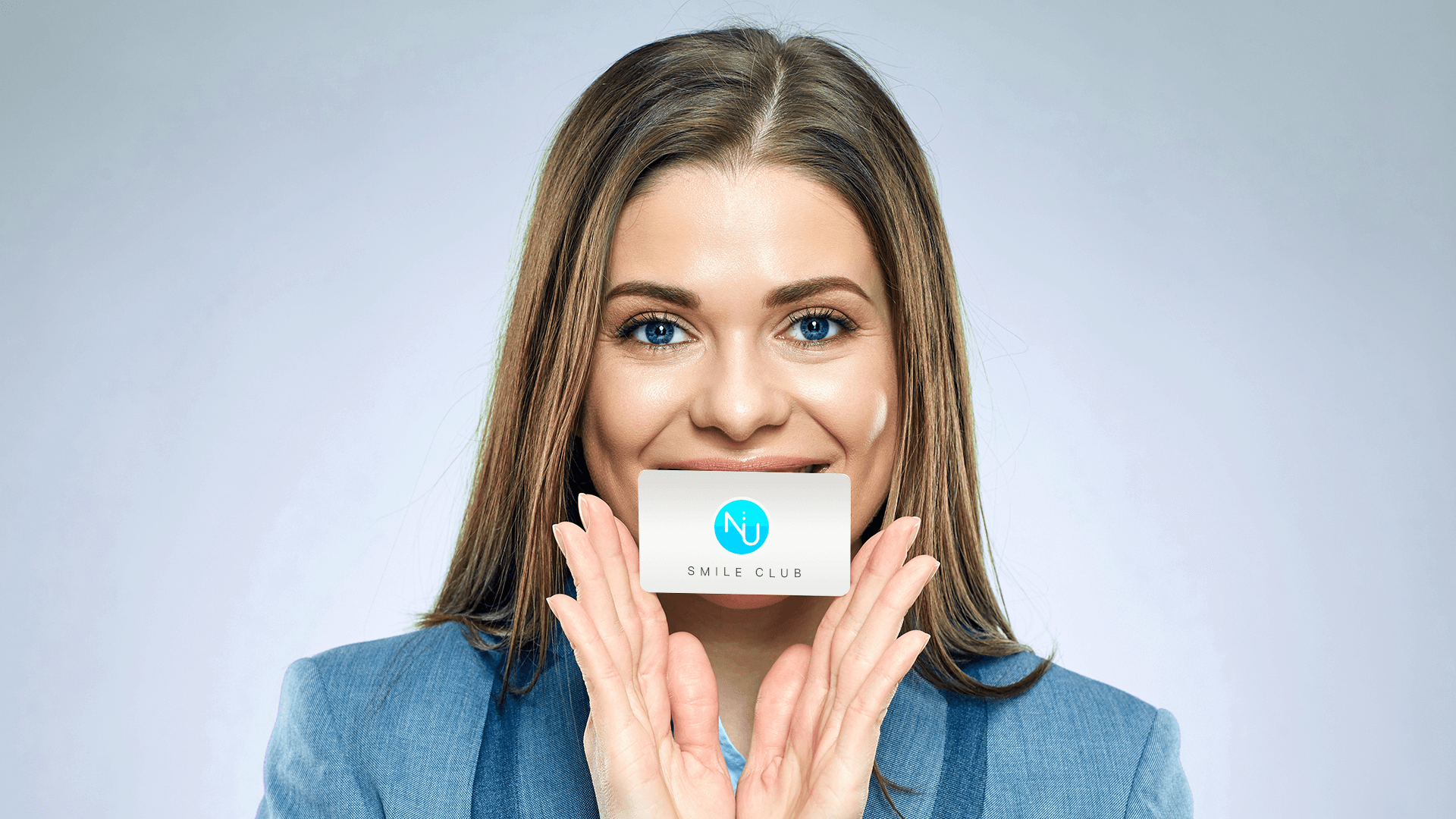 Woman holding Nu dentistry loyalty card
