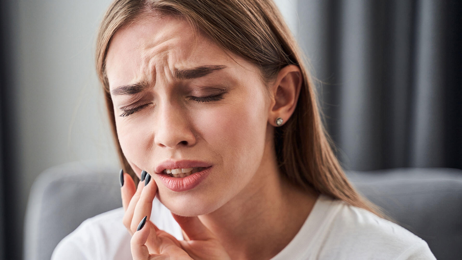 Woman experiencing a dental emergency